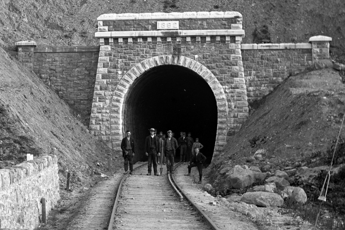 Men digging train tunnel through mountain