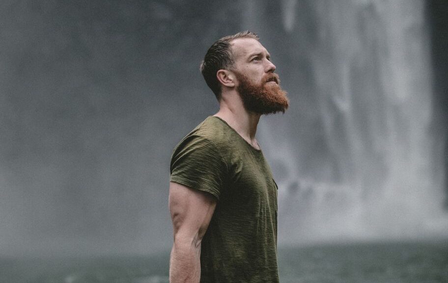 Man standing near waterfall